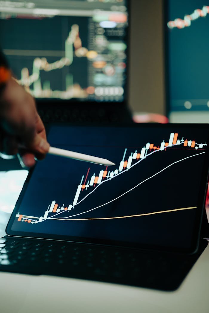 Close-up of a digital tablet showing a financial growth chart with graphs and trends under analysis.